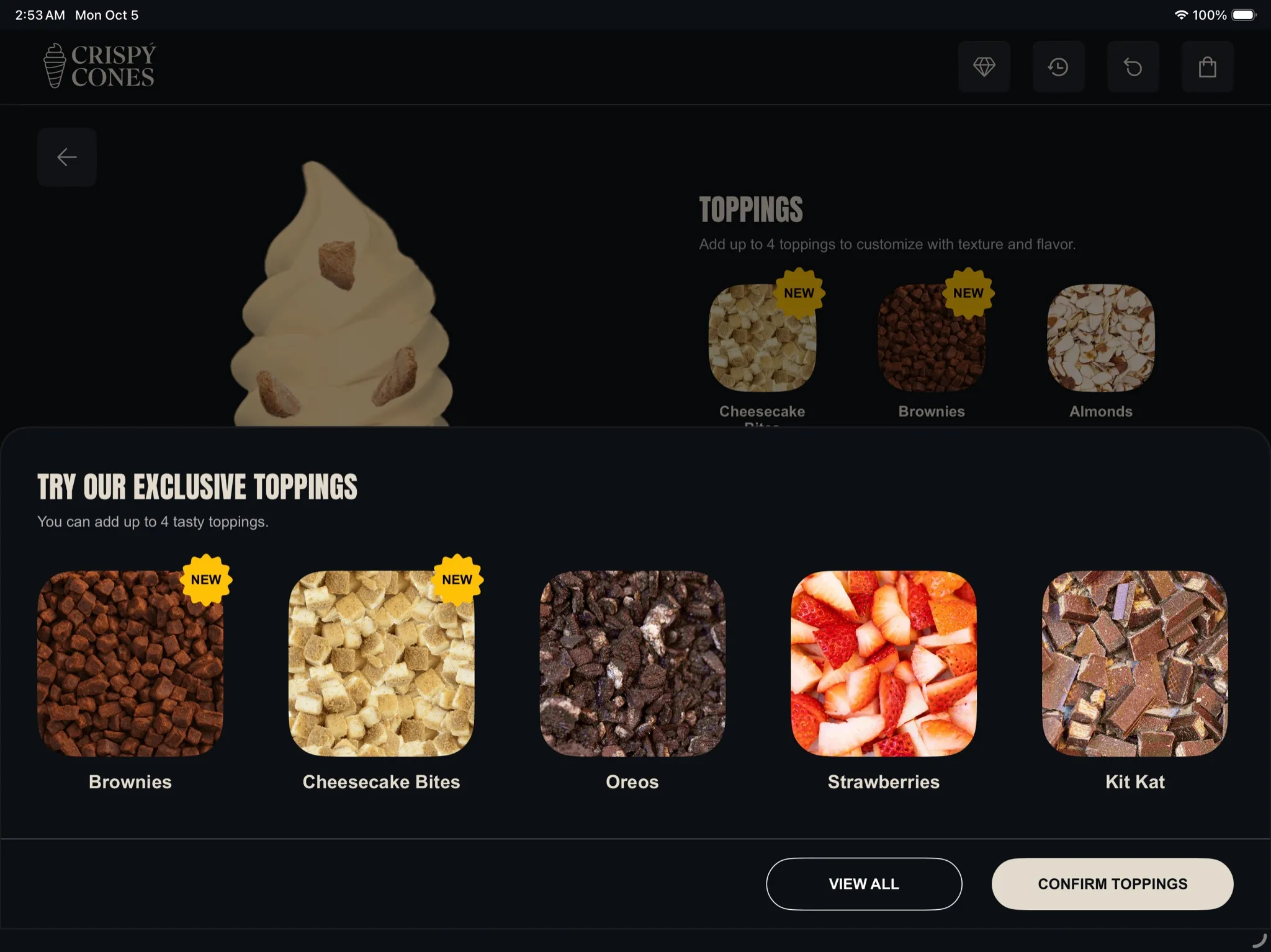 The kiosk suggesting exclusive toppings: Brownies, Cheesecake Bites, Oreos, Strawberries and Kit Kat.